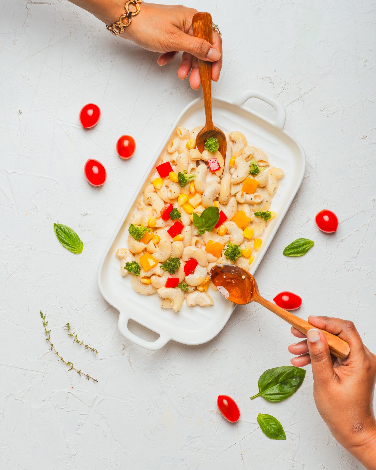 Lifestyle food photography flatlay of pasta salad with hands by NiRam Creatives Bangalore
